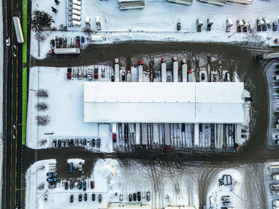 Aerial view of a snow-covered warehouse trailer yard