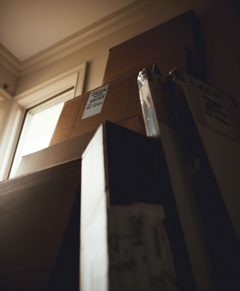 Leaning stack of shifted cardboard boxes