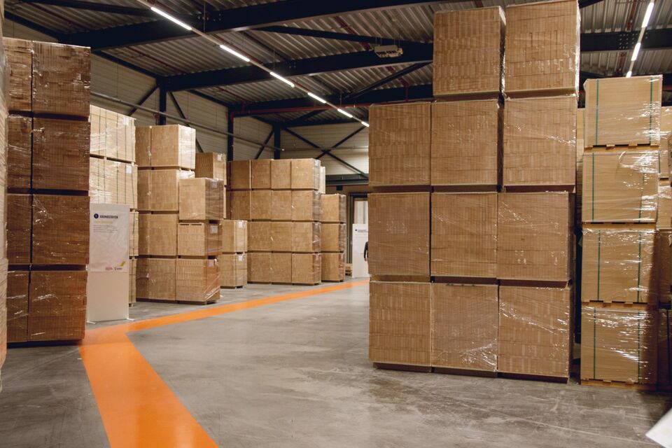 Rows of sealed cartons filling a warehouse floor
