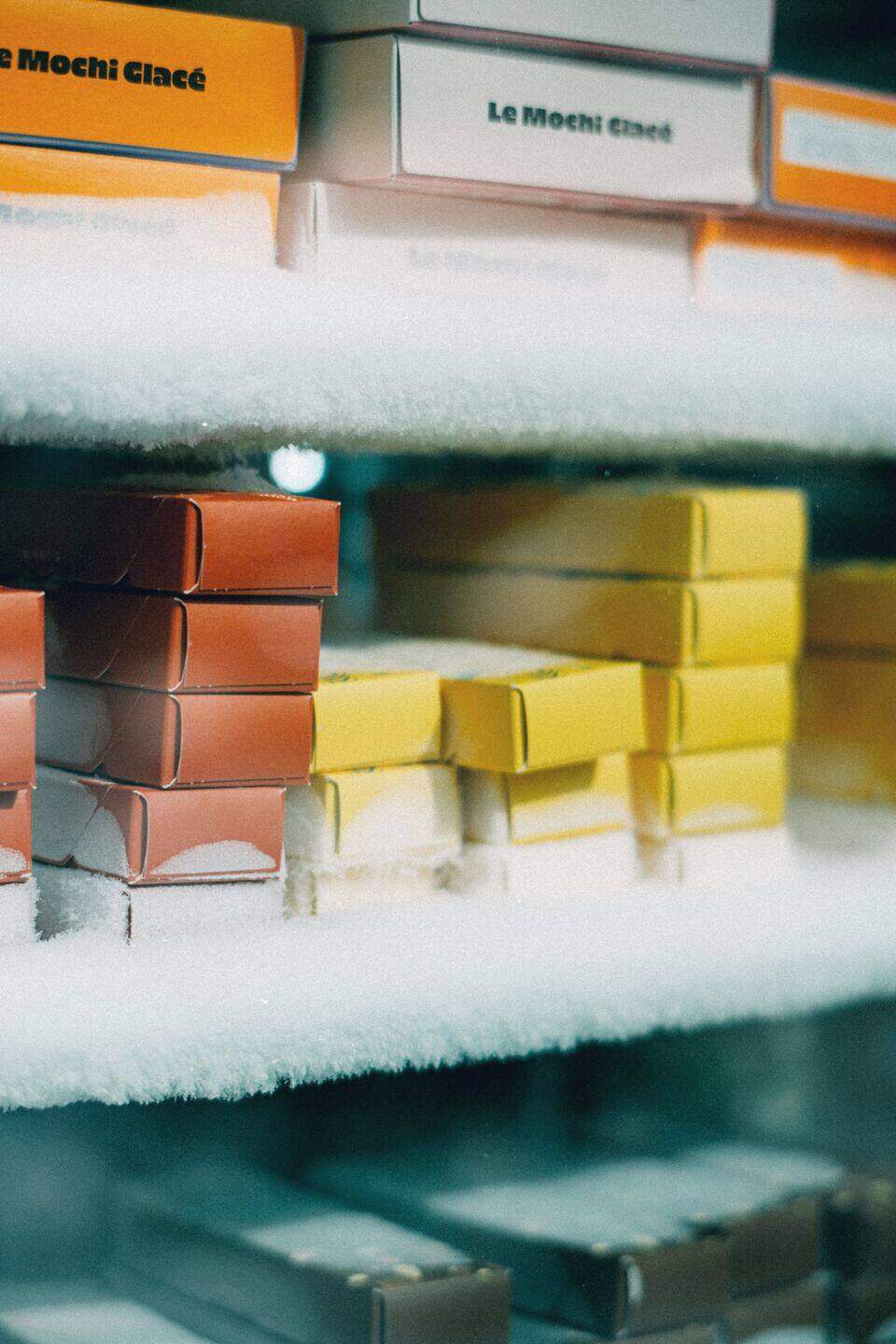 Frost-covered cartons stacked in a cold-storage room