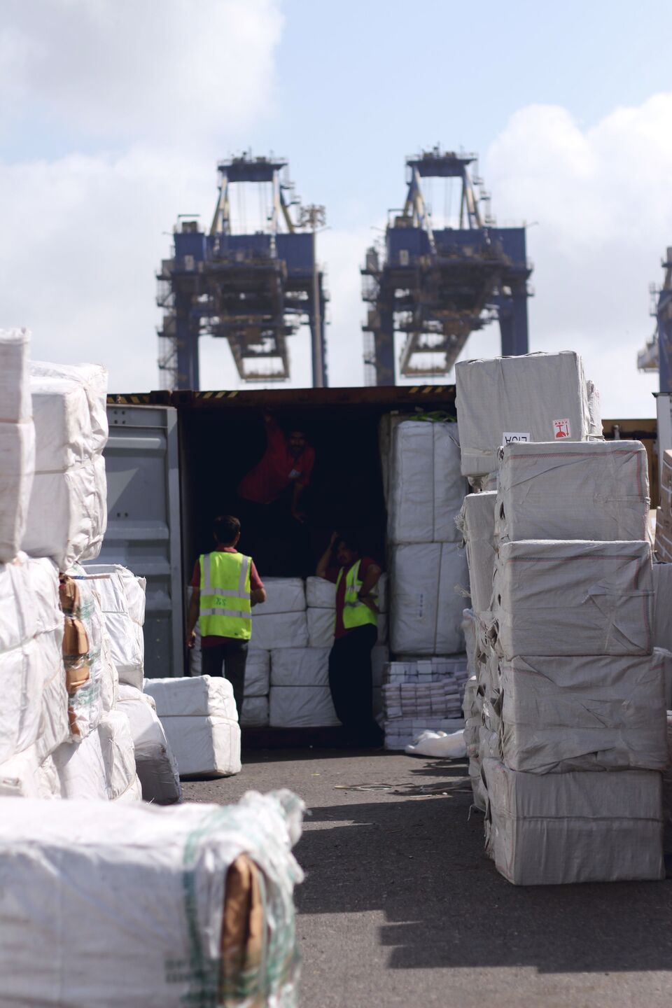 Open shipping container loaded floor-to-ceiling with cartons