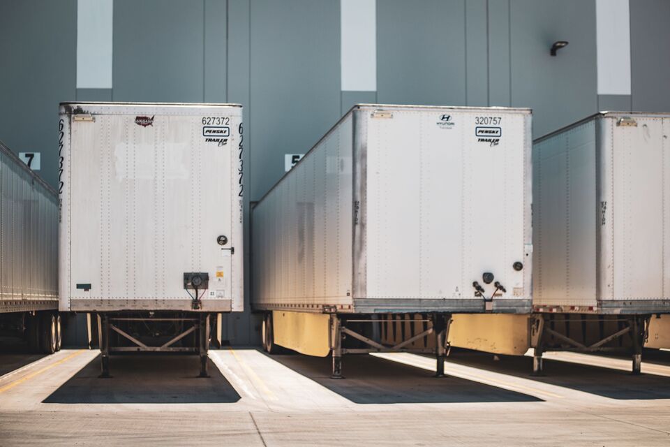 Rows of drop trailers parked in a yard