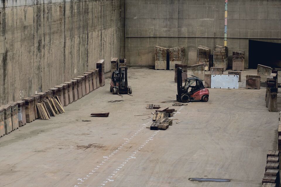 Forklifts working between warehouse racking
