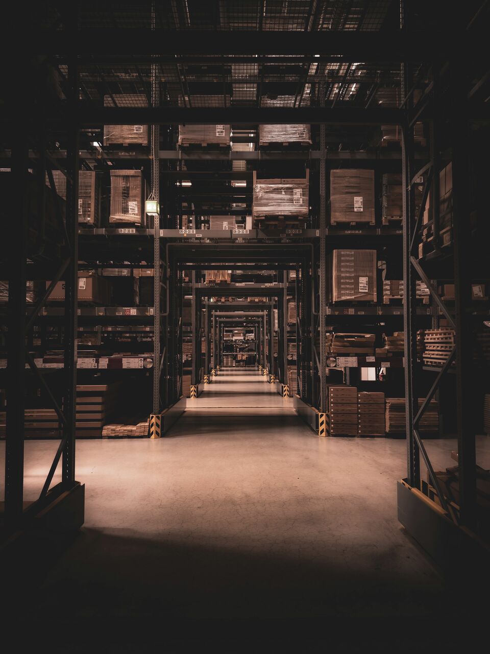 High-bay racking rising into darkness