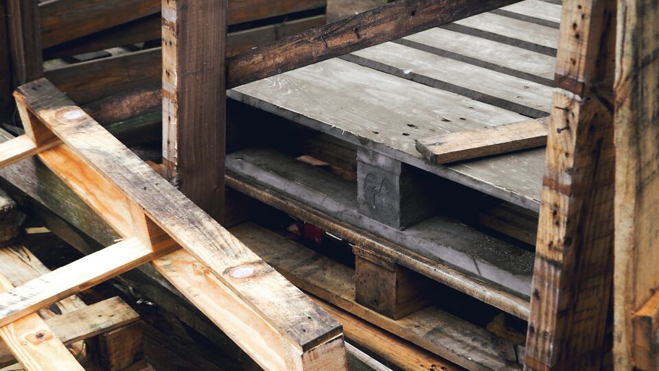 Rough wooden pallets stacked for disposal