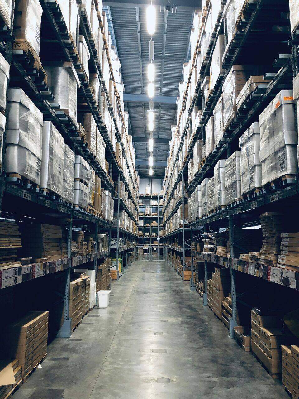 Tall warehouse racking aisle with amber picking lights