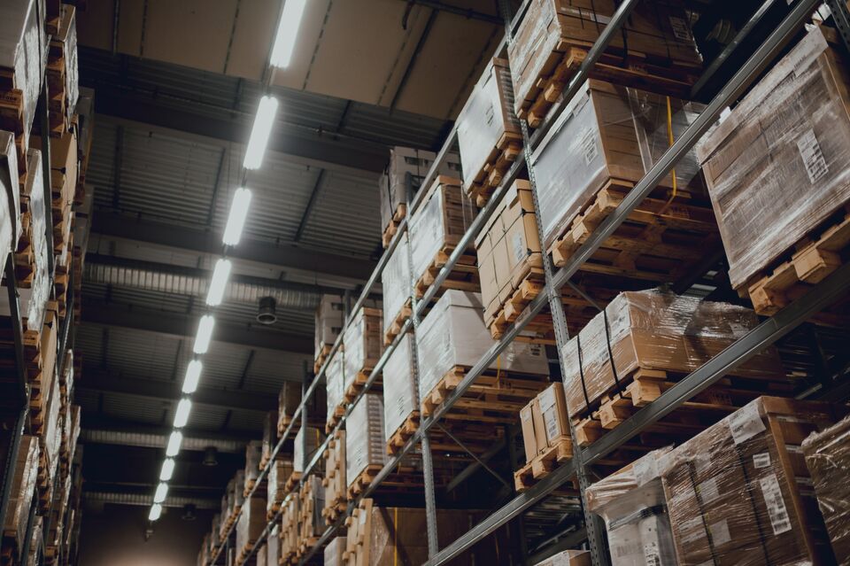 Dark warehouse racking under spot lighting