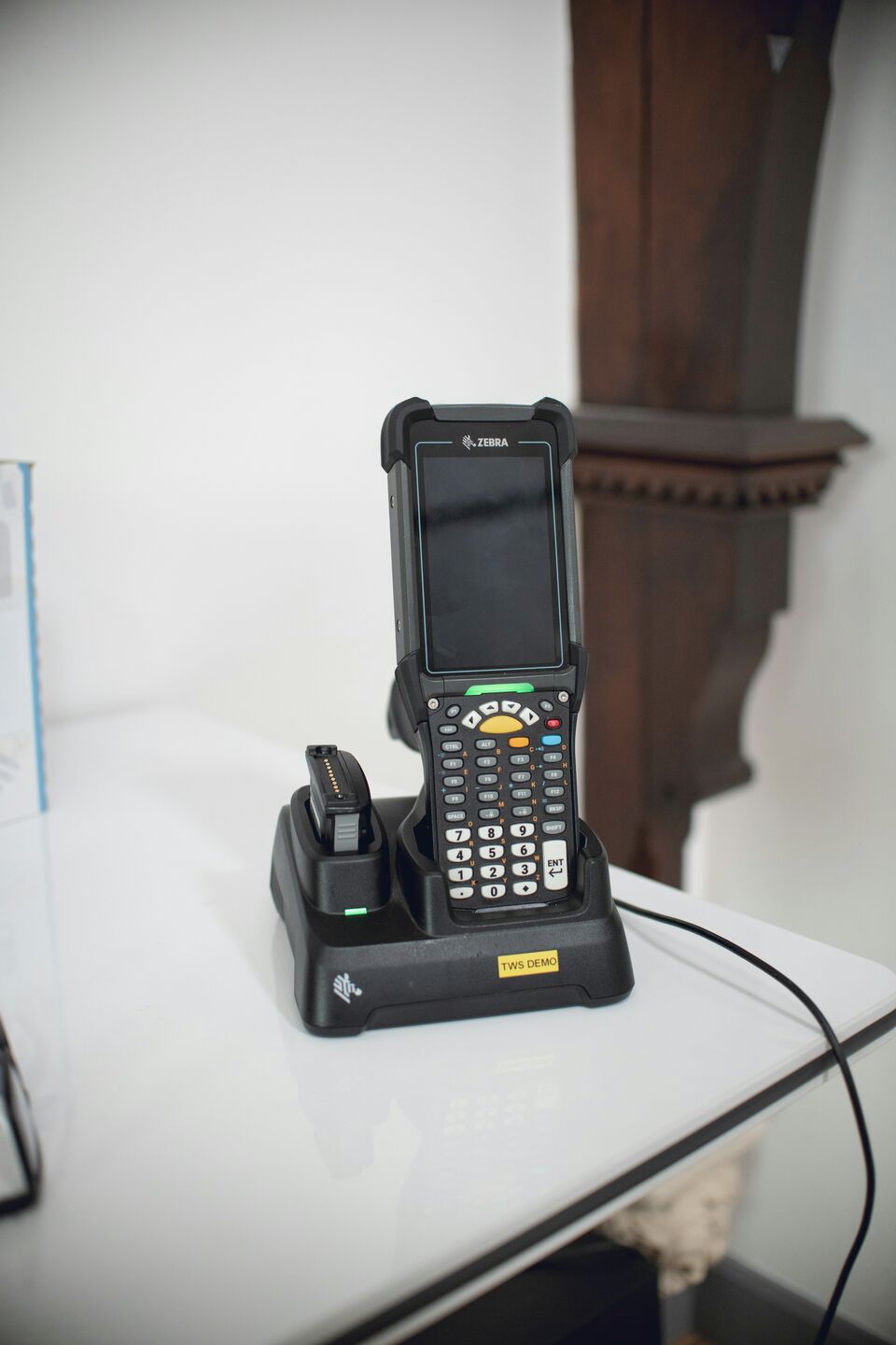 Barcode scanner resting in its dock at a workstation