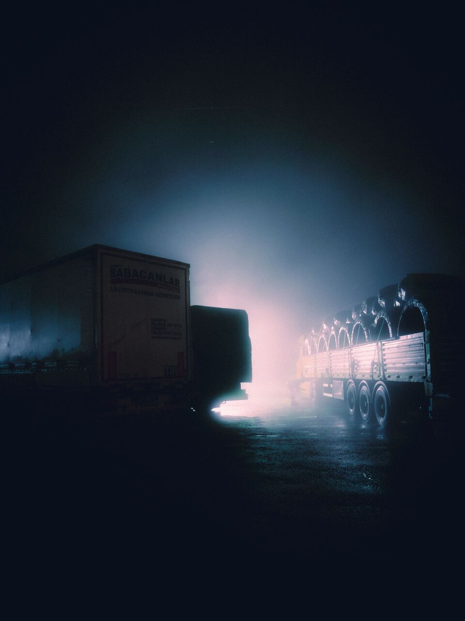 Truck yard at night with trailers in rows