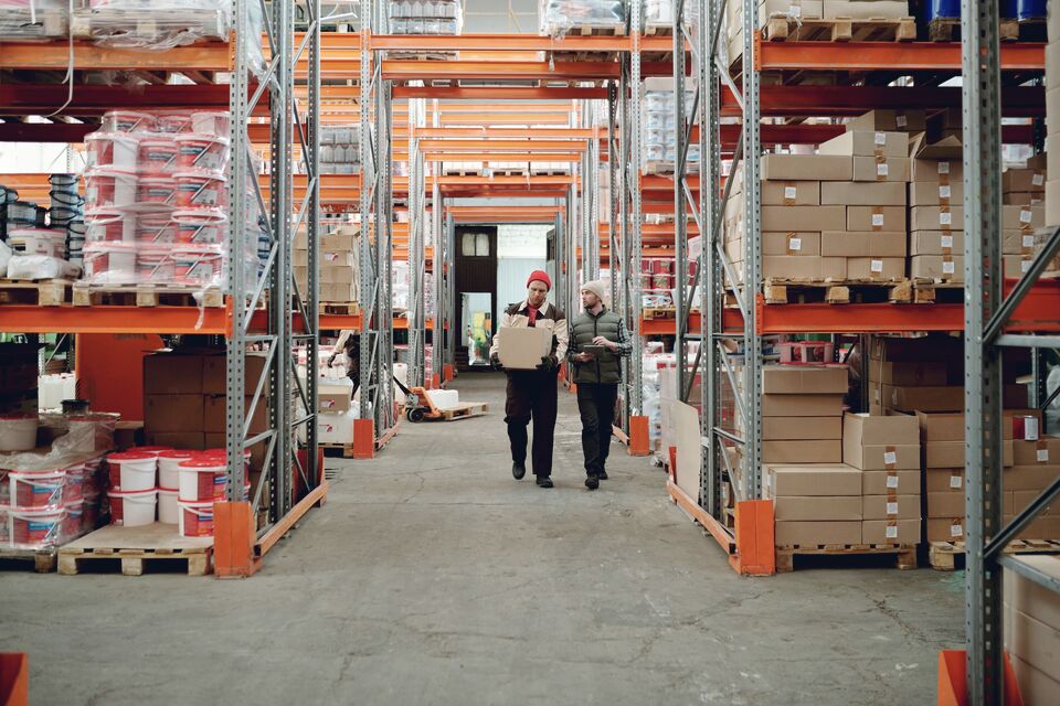 Worker stretch-wrapping a loaded pallet